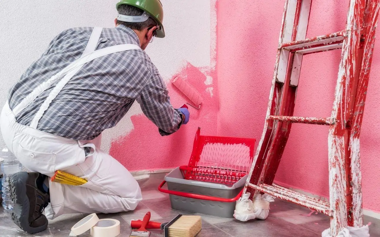 House painter in Philadelphia applying fresh exterior paint for a smooth, long-lasting finish.